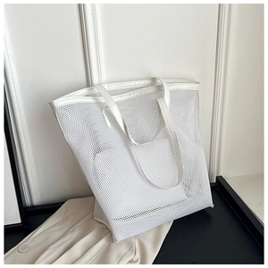 Minimalist white mesh beach tote bag shown in a professional lifestyle close-up shot