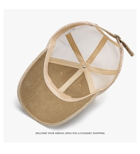Internal details of a khaki mesh trucker hat featuring the cotton wash label and adjustable strap