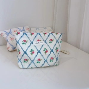 Vue détaillée de la trousse cosmétique fleurie en toile bleue avec fermeture éclair