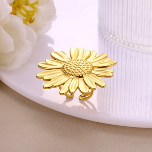 Adjustable golden hollow flower pearl ring with elegant sunflower design on white dish