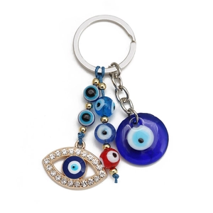 Detailed view of Evil Eye keychain with blue glass charms and rhinestone metal accents