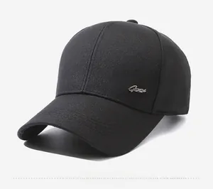 Dettaglio del berretto in cotone nero con logo in metallo argentato sul profilo