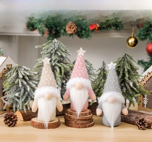 Close-up of knit Christmas gnomes with sequin stars and cozy heart patterns