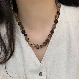 Vintage irregular agate beaded titanium steel necklace shown on a model neck