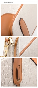 Detail showing beige textured leather with brown trim and gold metal hardware