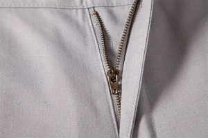 Detailed macro view of the durable metal zipper and smooth linen-cotton fabric texture
