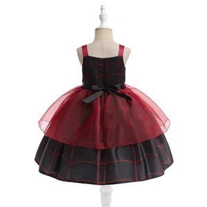 Detail view of girl's Halloween pumpkin dress back with red spider web tulle and bow