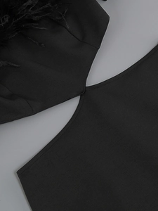 Detail of black off-shoulder dress featuring cutout design and delicate feather trim