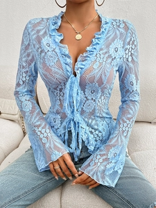 Close-up of blue floral lace top featuring elegant ruffle trim and flared bell sleeves