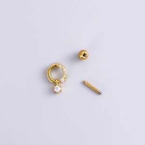 Golden double-ended bow heart stud earring with zircon inlay shown in a disassembled view