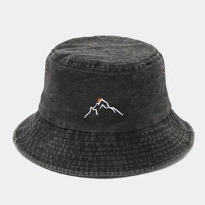 Detail view of mountain and sunset embroidery on washed charcoal bucket hat