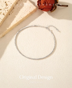 Macro detail of S925 sterling silver chain featuring textured cylindrical links and clasp