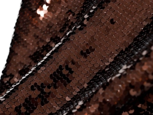 Close-up of high-density bronze sequins fabric on a fashion party dress for women