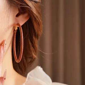 Minimalist geometric leather-wrapped hoop earrings with silver pins for women in dark brown