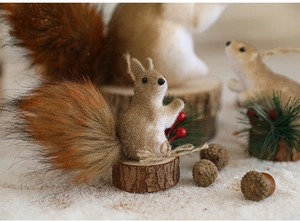 Detailed close-up of foam squirrel figurines with wood base and festive pine cone decor
