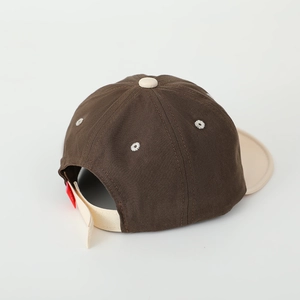 Detail view of adjustable back strap and breathable vents on kids two-tone baseball cap