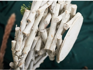 Detail of handcrafted white rustic wooden candle holder with natural branch textures