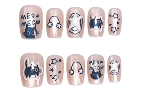 Detail view of pink cat eye press-on nails featuring cute cat and star illustrations