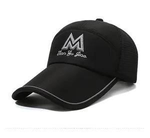 Close-up of black mesh baseball cap with silver M embroidery and long visor detail
