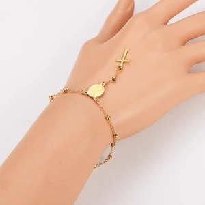 Detail of 18k gold plated stainless steel bracelet with virgin mary medal and cross charm