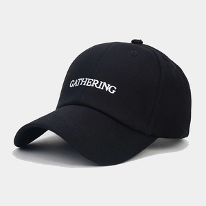 Detail showing the white 'GATHERING' embroidery on a premium black cotton baseball cap