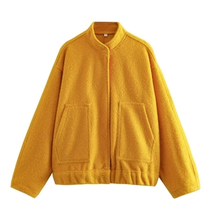 Close-up of yellow fleece jacket texture with stand collar and size S tag detail