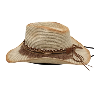 Detail of straw cowboy hat with braided leather band, metal chains and brown tassels