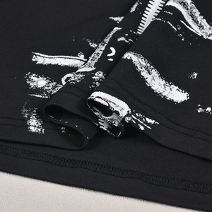 Detailed macro view of black cotton knit fabric with white distressed abstract print