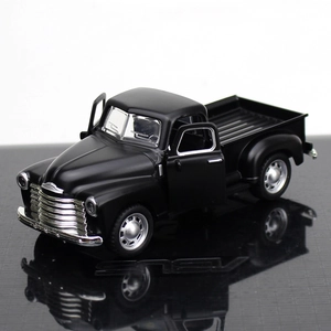 Macro detail of classic matte black alloy pickup truck model with open doors and chrome grille