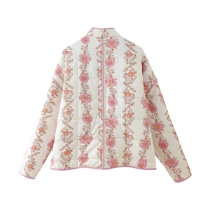Detail view of the floral print quilted jacket back with pink piped edges and high collar