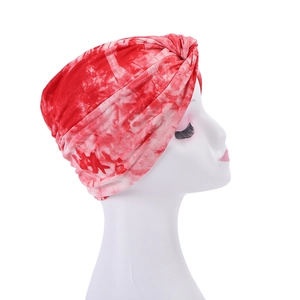 Detail showing red and white tie-dye fabric texture and pattern of the headscarf