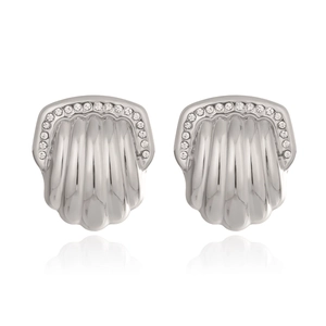 Macro detail of textured fan-shaped stainless steel earrings with sparkling crystals