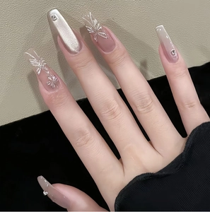 Macro view of coffin nails with silver cat eye finish and 3D butterfly charms