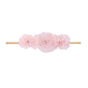 Detail view of baby flower headband with chiffon petals, pearls and elastic nylon band