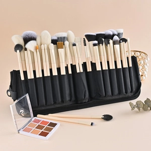 Detailed set of professional makeup brushes with wooden handles in a black roll-up pouch
