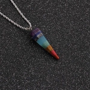 Close-up of conical chakra stone pendant with seven colorful gems on silver twist chain