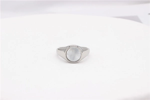 Detailed view of silver minimalist round ring with white shell inlay and natural texture