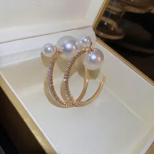 French style gold hoop earrings with white pearls and sparkling pavé crystal accents