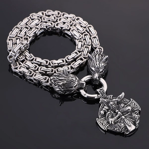 Detailed shot of Viking wolf heads and Odin pendant on a steel Byzantine chain