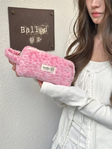 Detailed close-up of a pink plush leopard print makeup bag with a soft faux fur handle