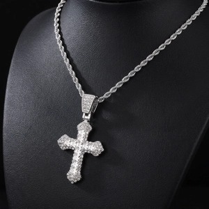 Detail shot of a silver hip hop cross pendant with sparkling rhinestones on a rope chain