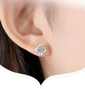 Close-up of S999 sterling silver clover stud earring with sparkling cubic zirconia inlay