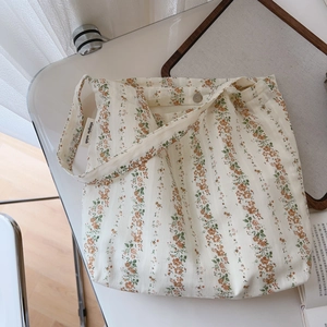 Floral cotton shoulder bag in orange-pink featuring magnetic closure and minimalist design