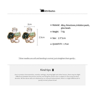 Vue détaillée de boucles d'oreilles fleurs mesurant 2,5 x 2 cm en or et perles blanches