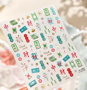 Macro shot of Mahjong nail stickers with gold foil, dice motifs, and Good Luck text