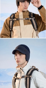 Close-up of winter knit baseball caps and outdoor hiking gear in snowy mountain landscape