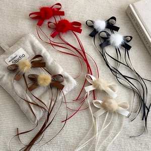 Ballet style hair clips with pom poms and long ribbons in four elegant colors