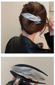 Macro detail of a large marble texture acetate hair clip with modern streamlined design