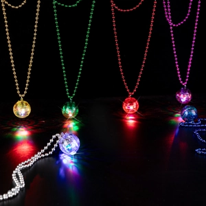 Retro multi-colored disco ball necklaces with reflective glow on a dark background