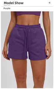 Detail view of deep purple women's athletic shorts with drawstring waist and pockets